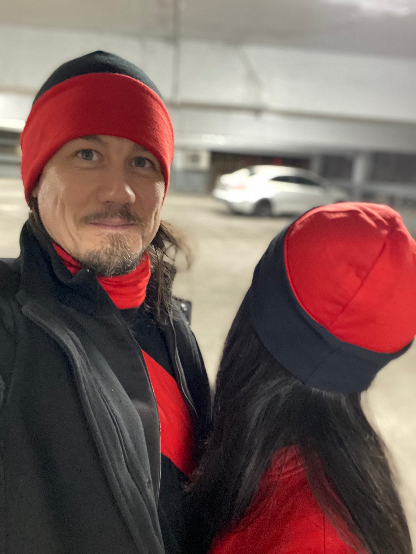 Reversible red and black hat from ELZI.ca. Models Jonathan and Sanaz.