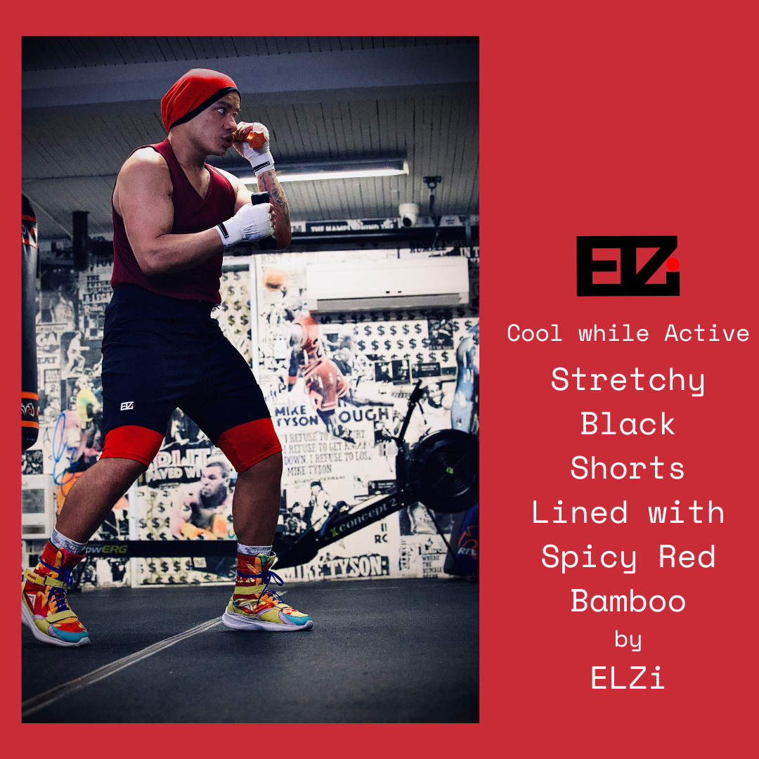 Coach at the counter back studio 5335A Sherbrooke West wearing the ELZi Stretchy Black Shorts lined with bamboo doing some good foot work with weights in his hands.
