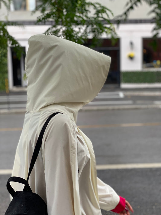 WHITE Rain Coat ELZI. Photograph Jonathan Brunelle
