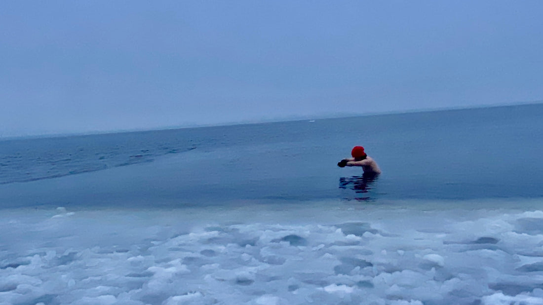 Cold plunge wearing ELZi bamboo beanie hat, bamboo neck warmer, bambo liner runner shorts and merino red underwear.  