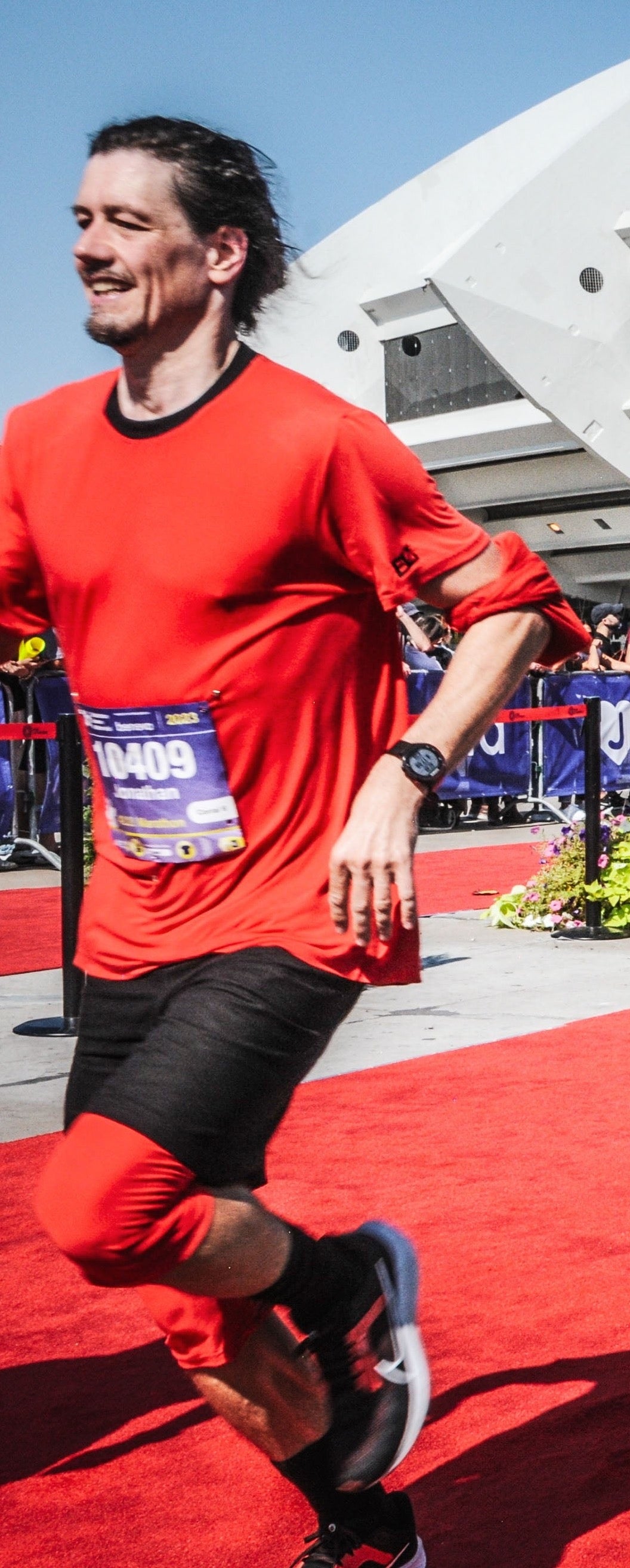 Jonathan Brunelle runs on the red carpet of the finish line of the beneva montreal marathon.
